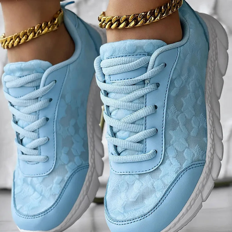 Women's canvas running shoes in white, black, blue, and pink colours with flat heel design