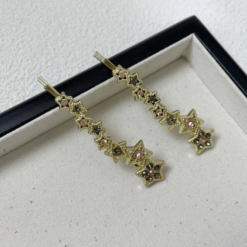 Gold Korean-style alloy hair barrettes with broken clip and star decoration.