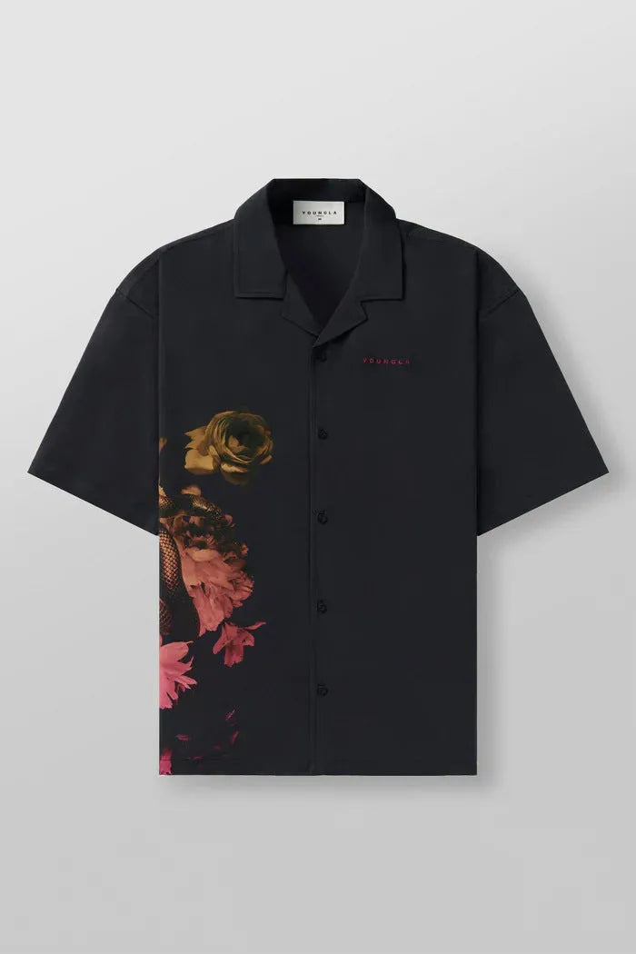 A man's loose-fitting, short-sleeve casual top with a floral print, shown in a light colour.