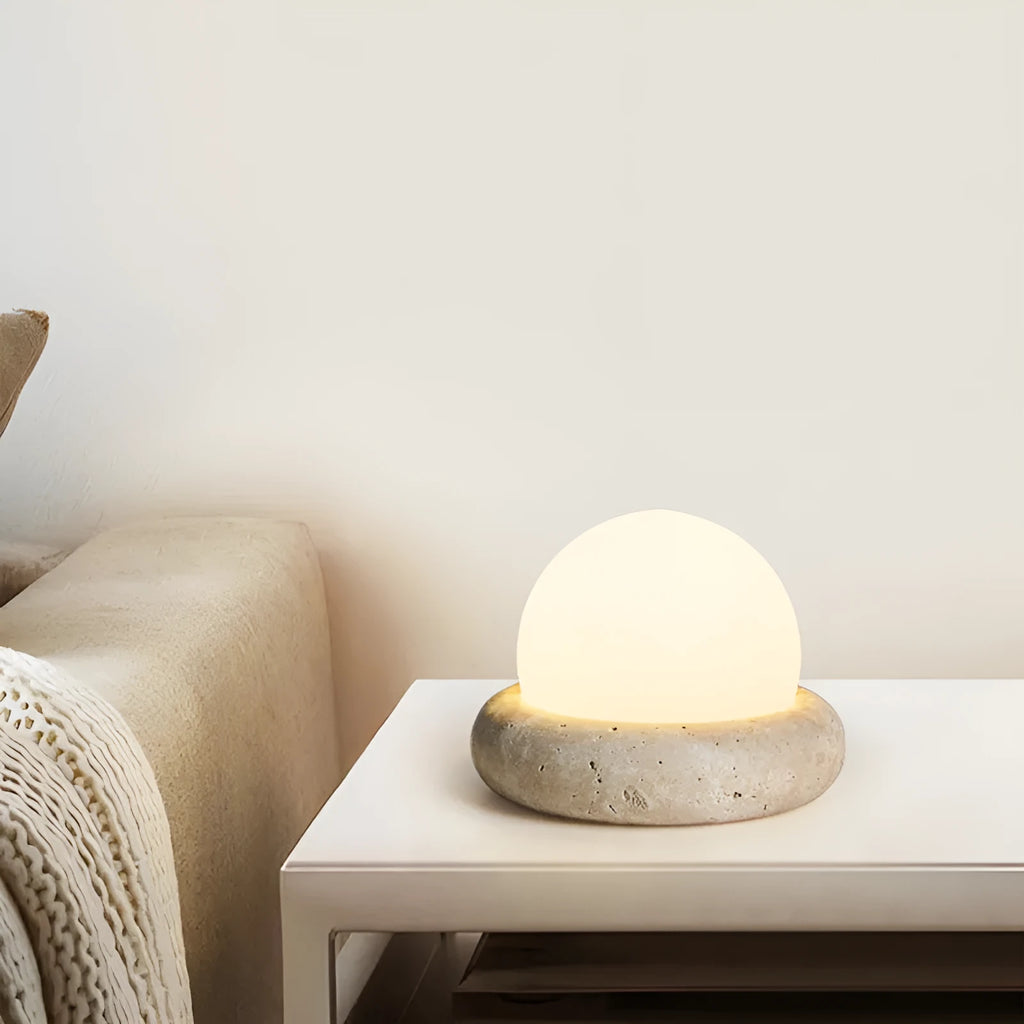 Cream-coloured modern bedside night lamp with remote control on wooden table