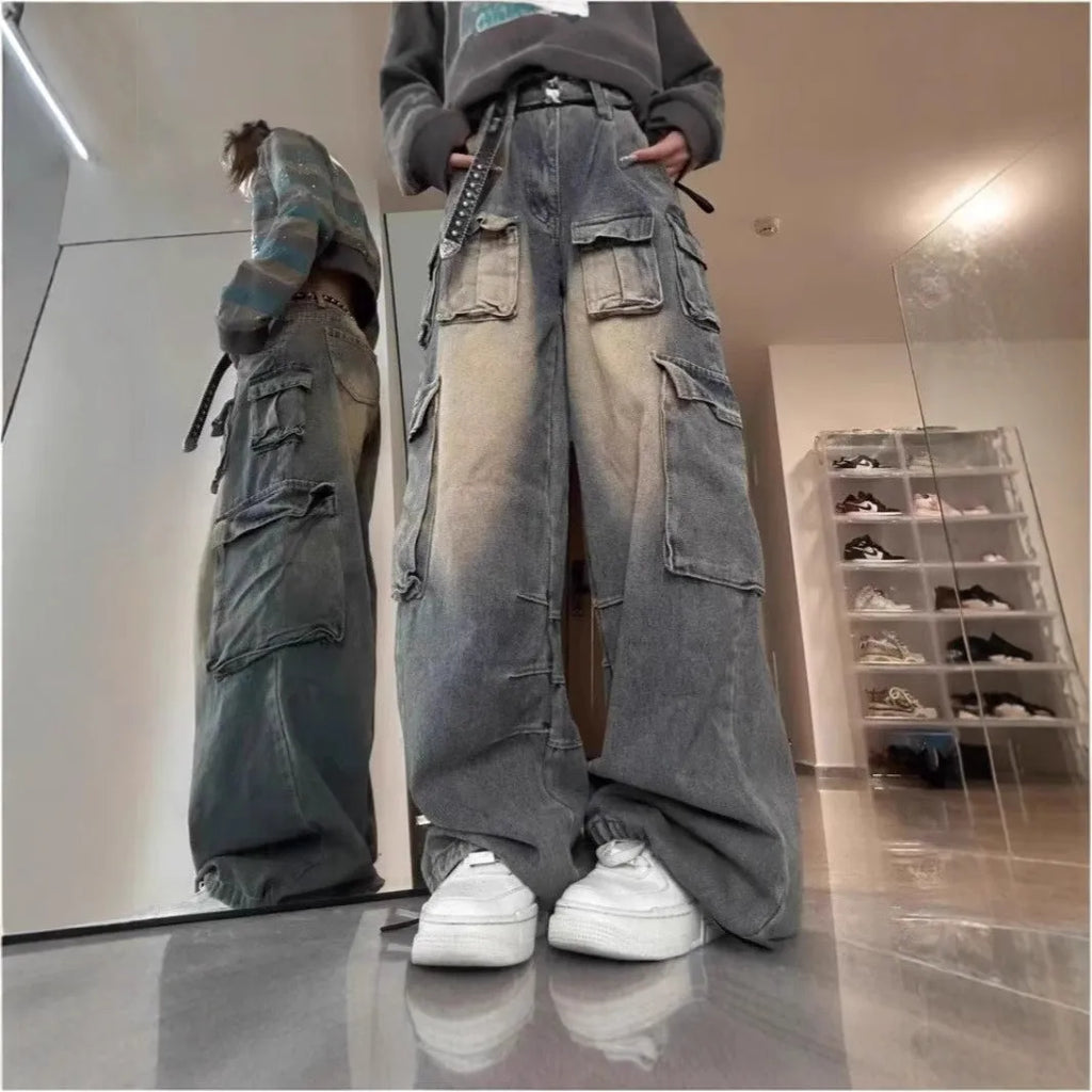 Light blue loose-fit multi-pocket distressed jeans on a hanger