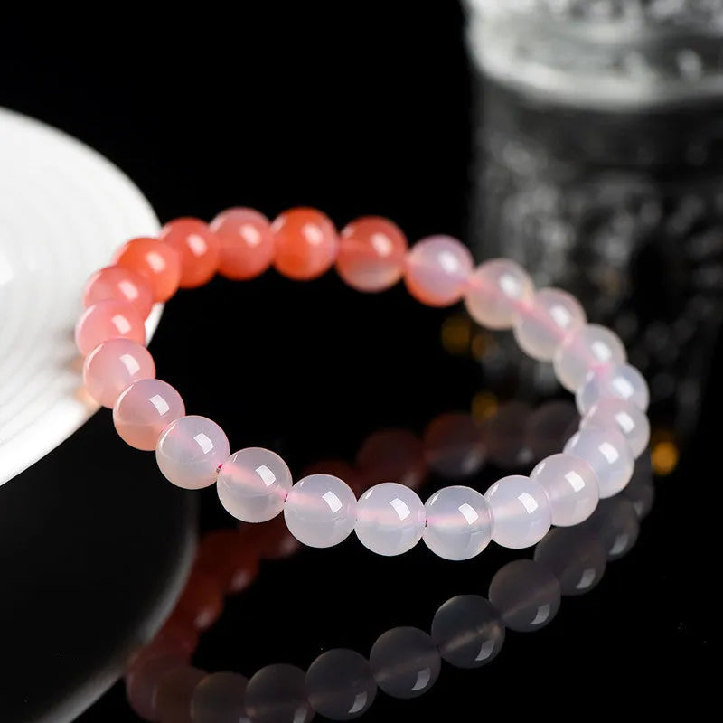 Natural gradient colour agate bracelet with geometric beads on a wrist.