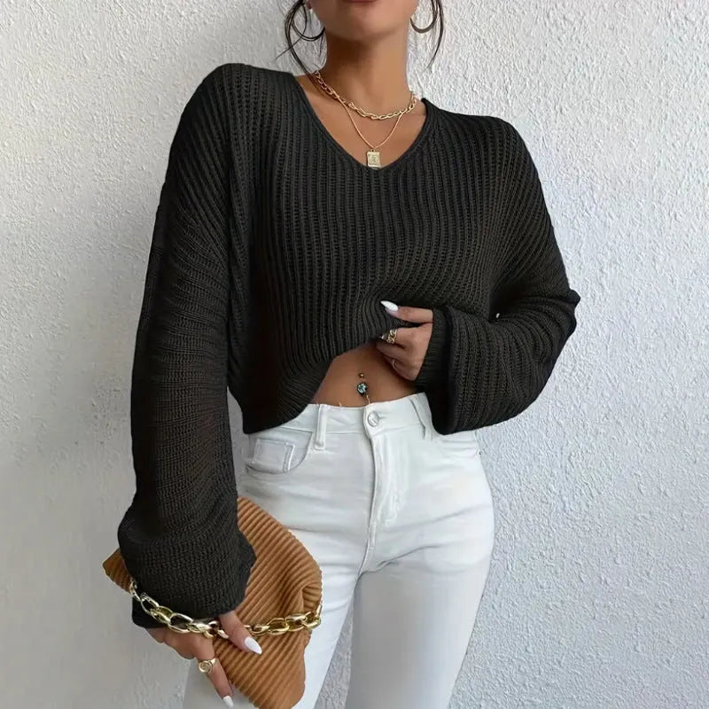 A woman wearing a solid colour long sleeve pullover in a loose, casual fit.