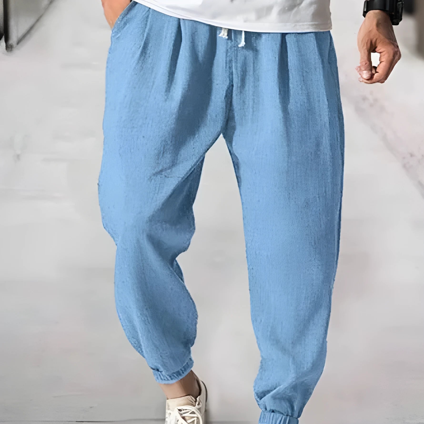 Men's loose casual cotton trousers with an elasticated ankle band in light green.