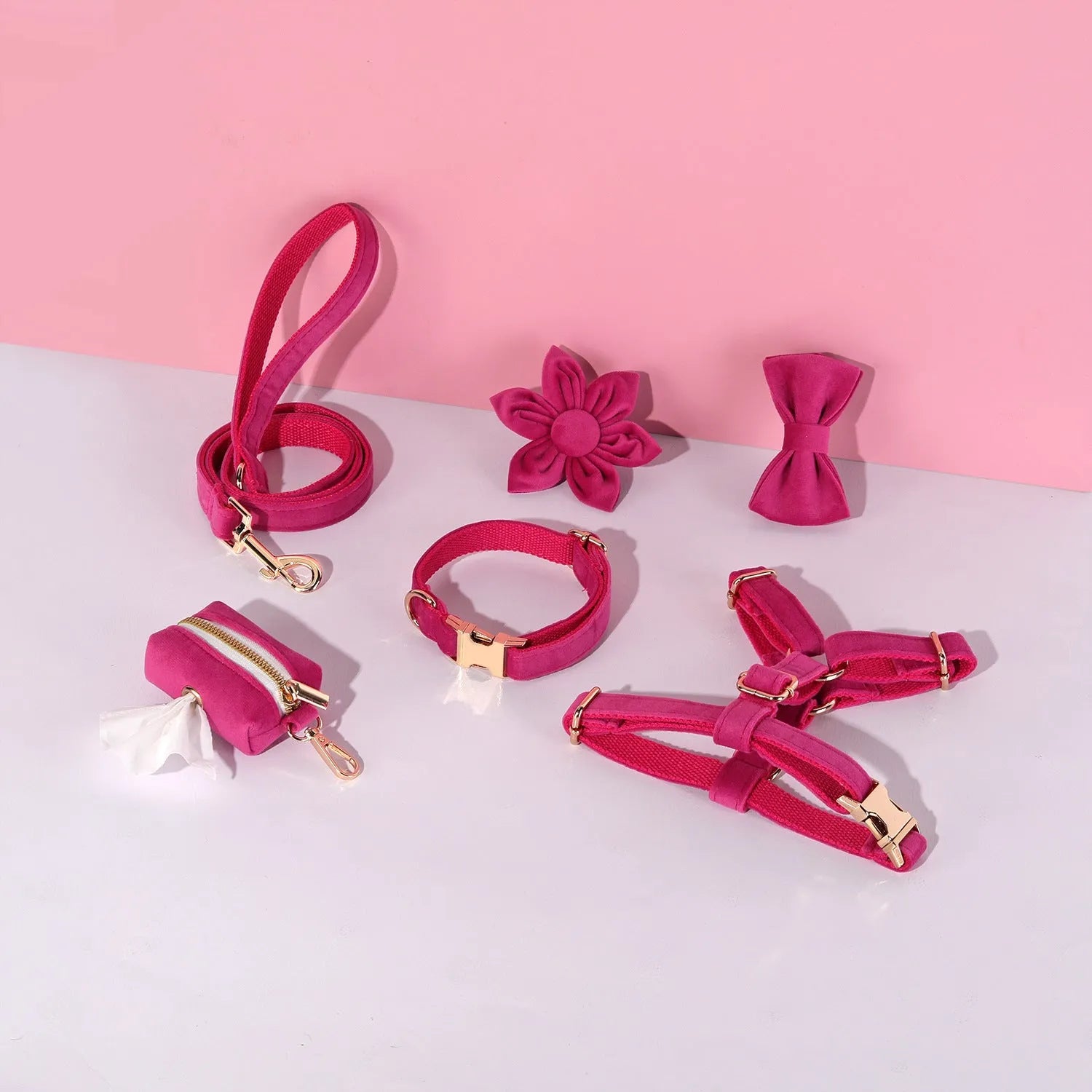 Classic velvet dog harness and lead set in red fleece with attached bow tie and waste bag holder.