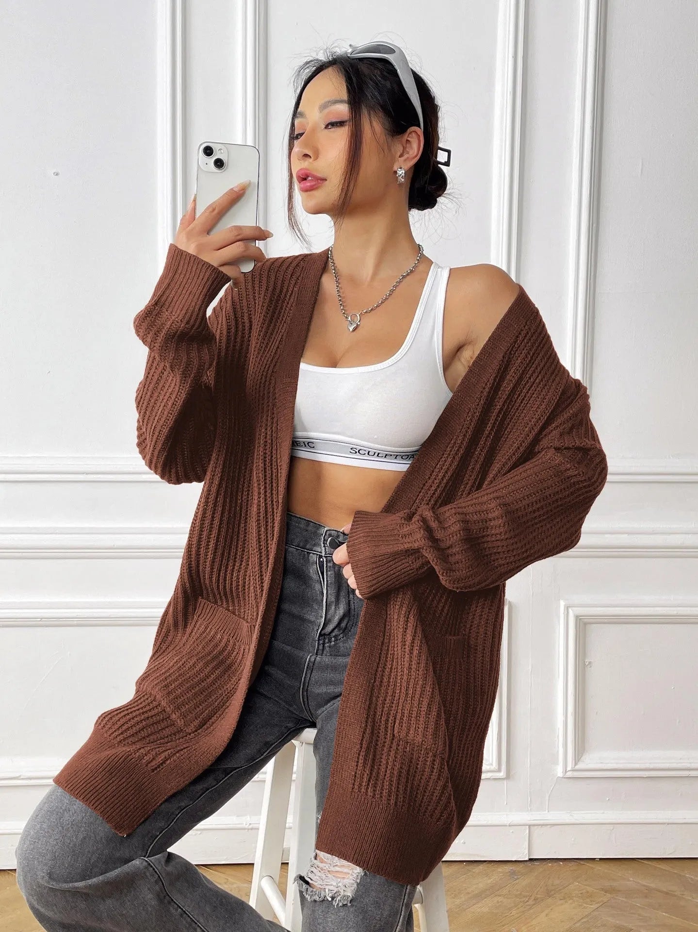 Women's double pocket casual cardigan sweater in dark green, loose mid-length fit.