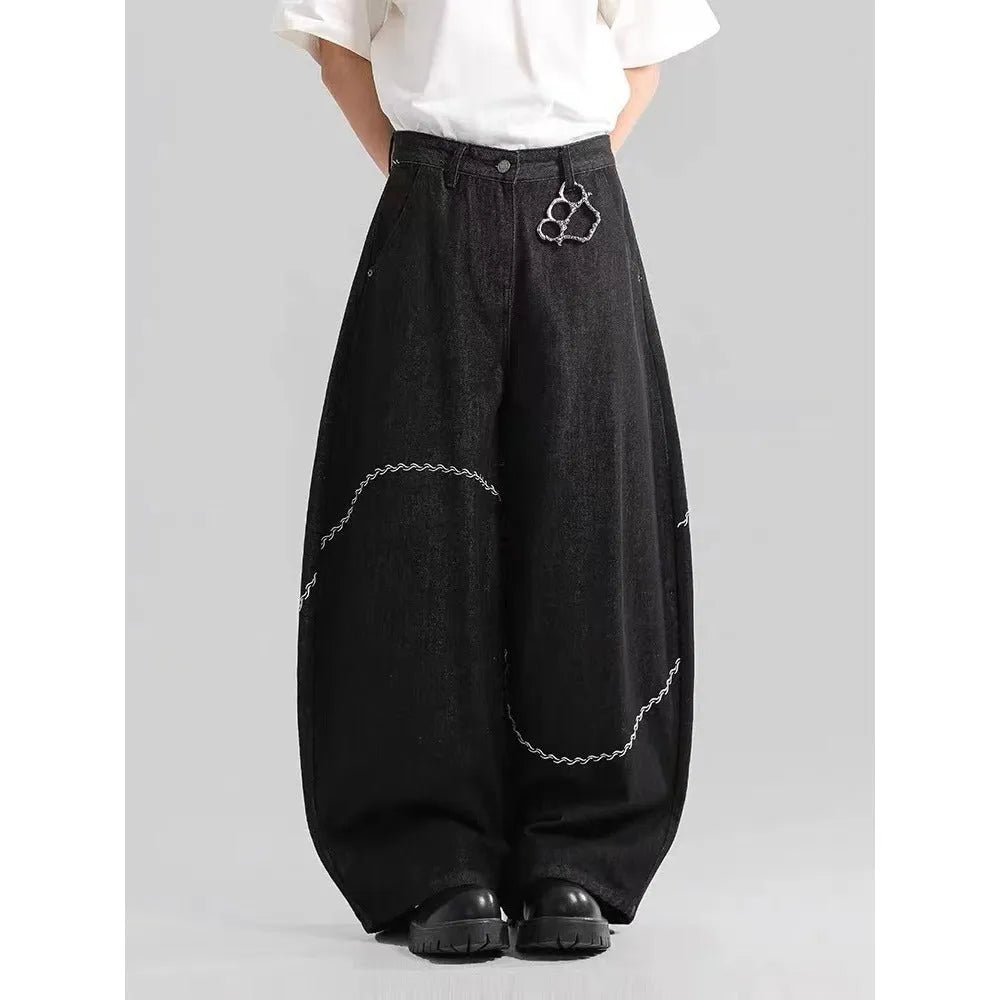 Black straight-leg denim trousers with a mid-waist and zip fly on a mannequin.