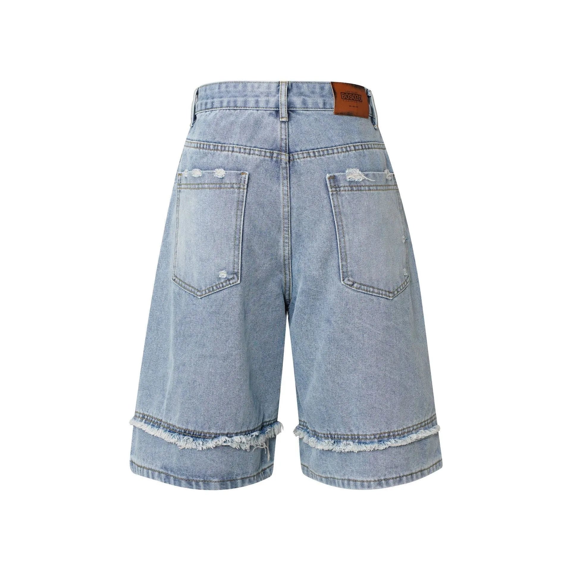 Distressed raw edge denim shorts in light blue, shown on a model.