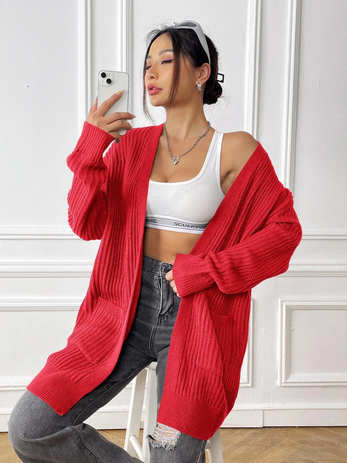 Women's double pocket casual cardigan sweater in dark green, loose mid-length fit.