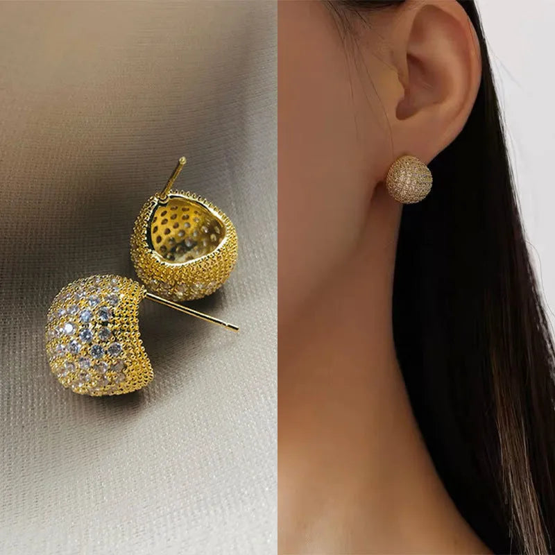 Gold and white geometric drop earrings with sparkling diamond-cut bean spheres.
