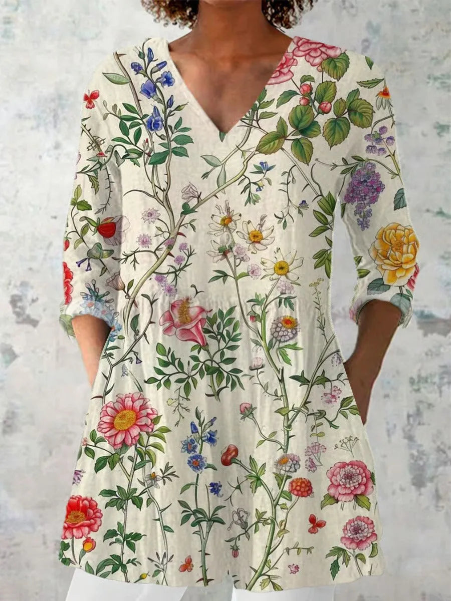 Women's slim-fit retro printed long-sleeved polyester top on a hanger, showing detail of digital print.