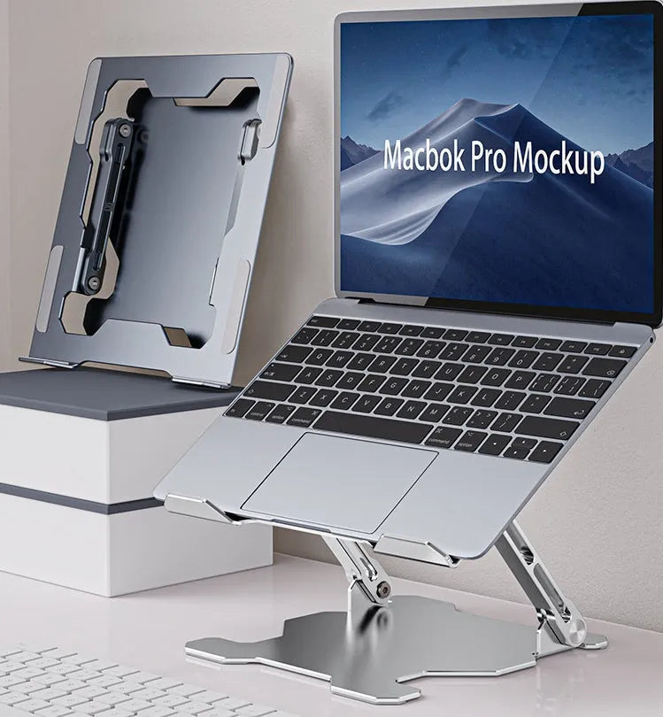 Grey aluminium folding laptop stand holding a silver laptop at an angle on a wooden desk.