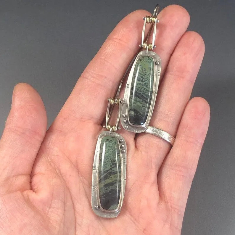 Geometric alloy earrings with black and white marble pattern showing front and side views