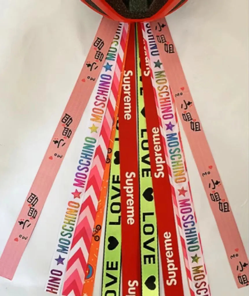A decorative streamer ribbon accessory for attaching to a child's roller skating, ski, or balancing car helmet.