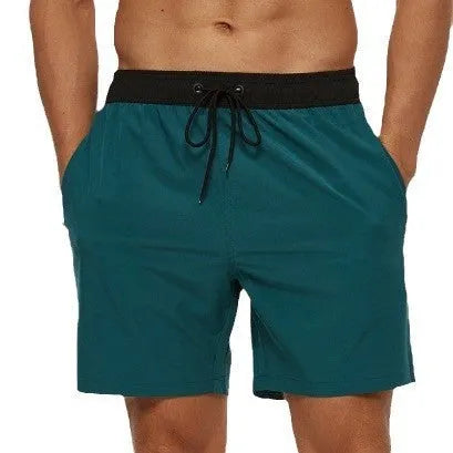 Men's blue running shorts with stitching waistband, zipper pocket, and drawstring for fitness activities