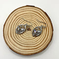 Silver leaf-shaped earrings with colourful moonstone stones embedded in alloy design
