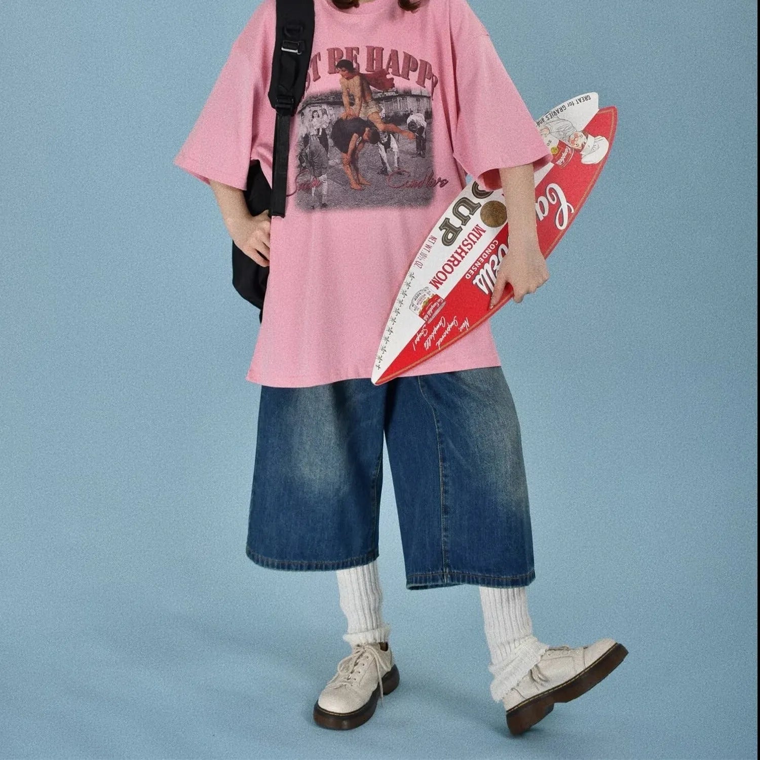 Man wearing blue loose straight-leg denim shorts with a simple summer style.