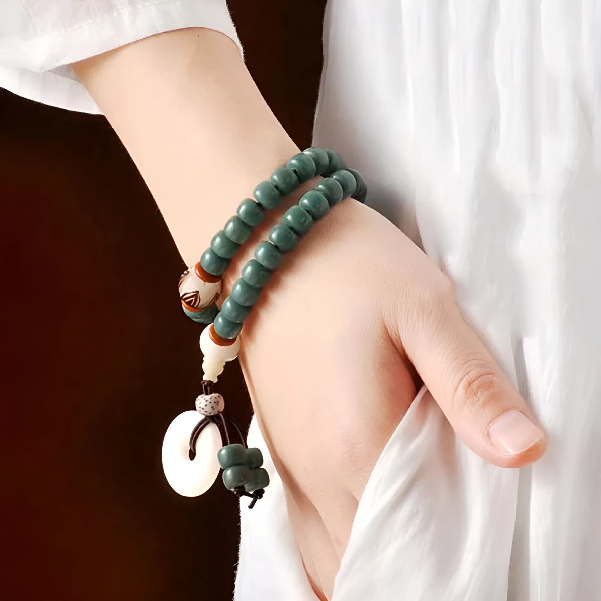Unisex natural Bodhi seed bracelet with white jade beads and green sandalwood on a white background.