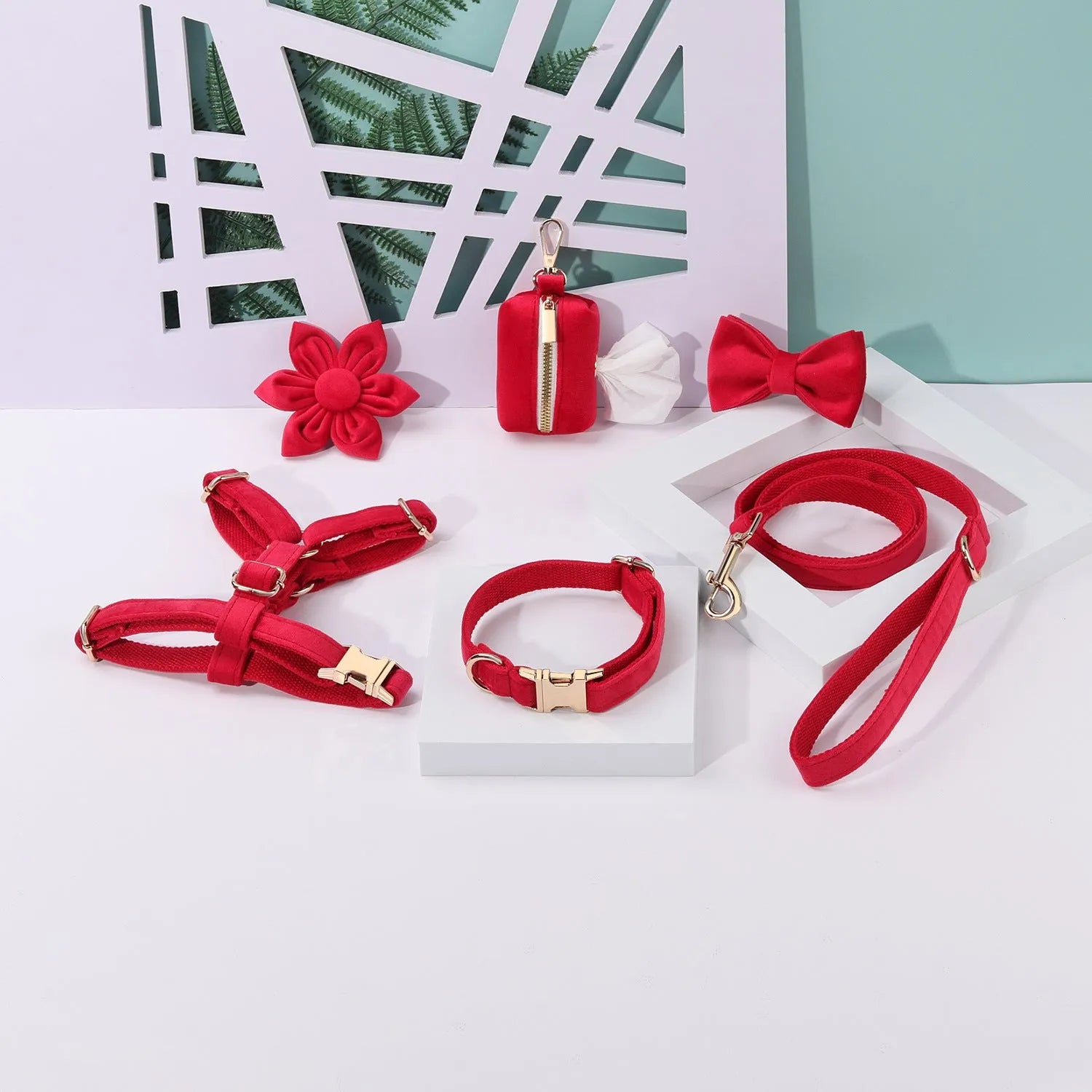 Classic velvet dog harness and lead set in red fleece with attached bow tie and waste bag holder.