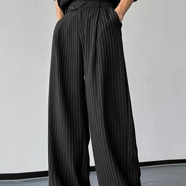 Black men's trousers with vertical stripes and pleats, made from an elastic rabbit hair and bamboo fibre blend.