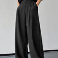 Black men's trousers with vertical stripes and pleats, made from an elastic rabbit hair and bamboo fibre blend.