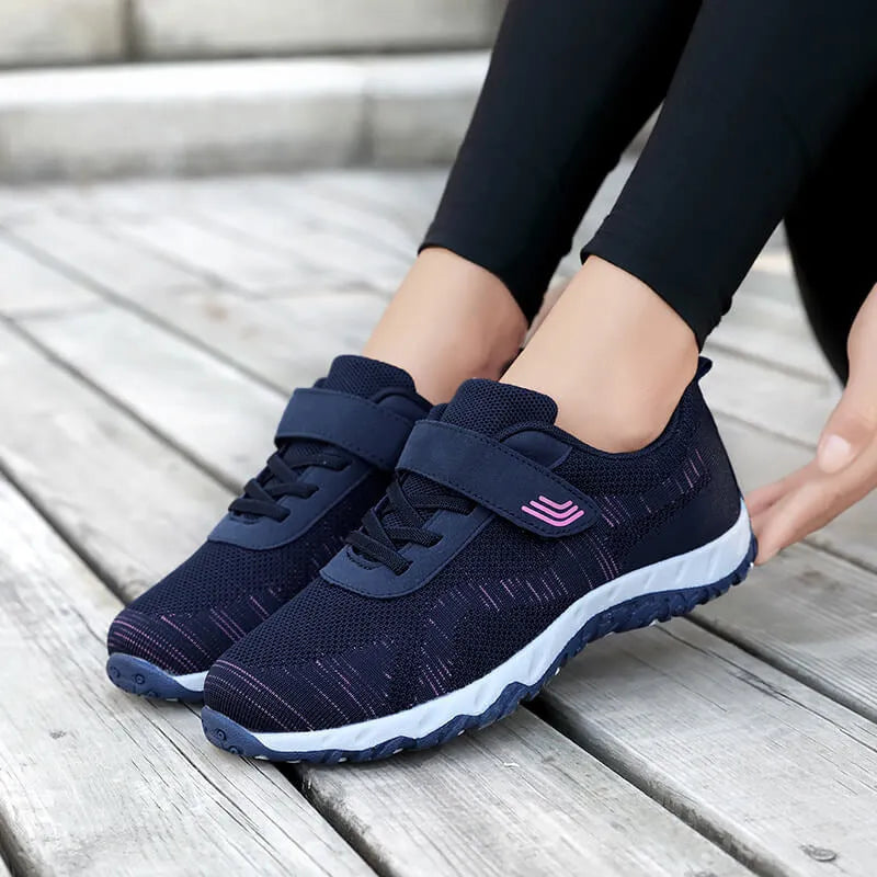Women's low-top wedge sneaker in grey purple with mesh upper and Velcro strap.