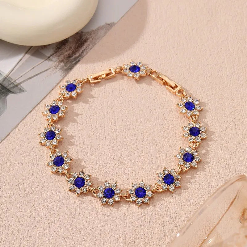 Gold and silver electroplated flower bracelet with coloured gemstone accents on zinc alloy