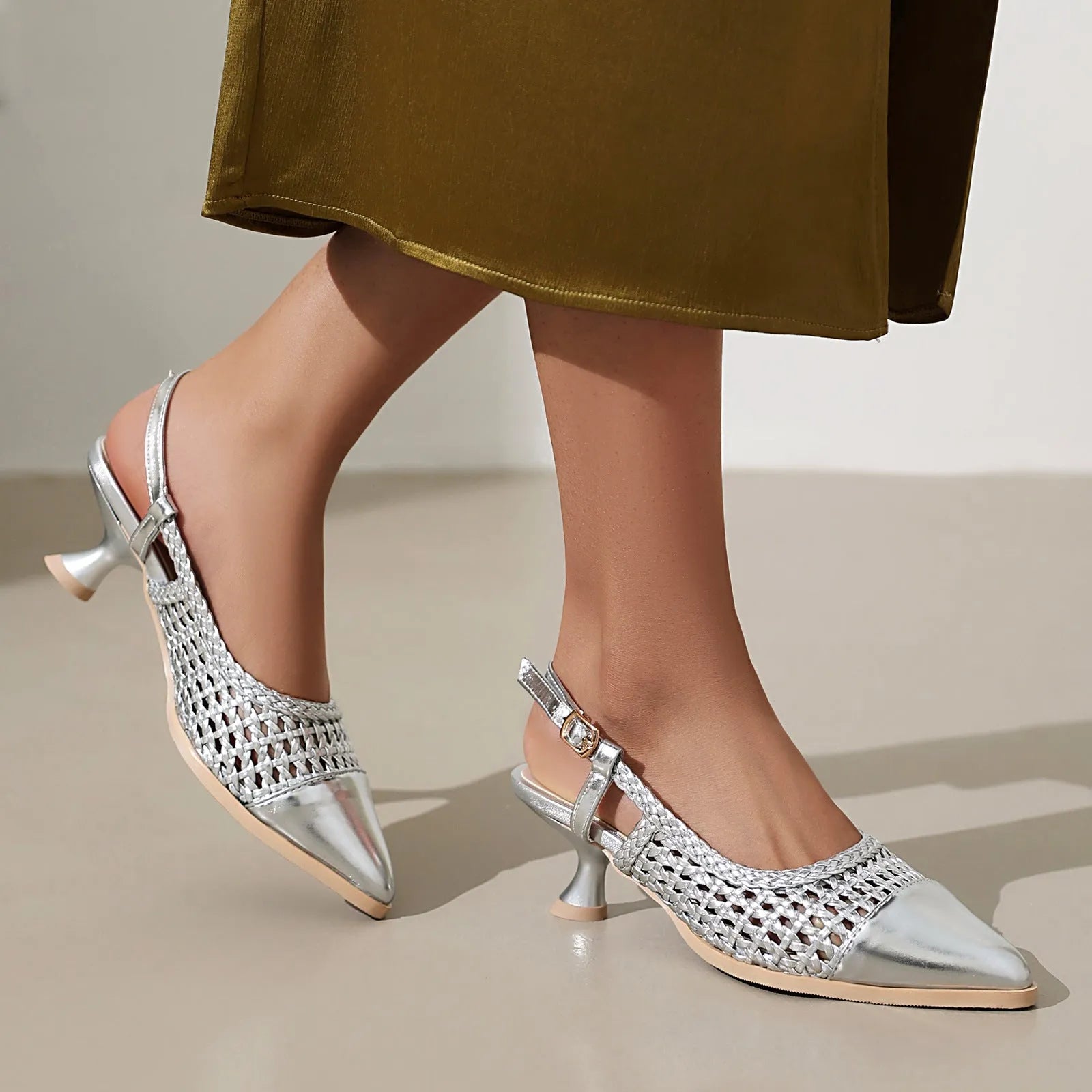 Black women's cat heel sandals with hollow-out design and buckle closure on a white background.