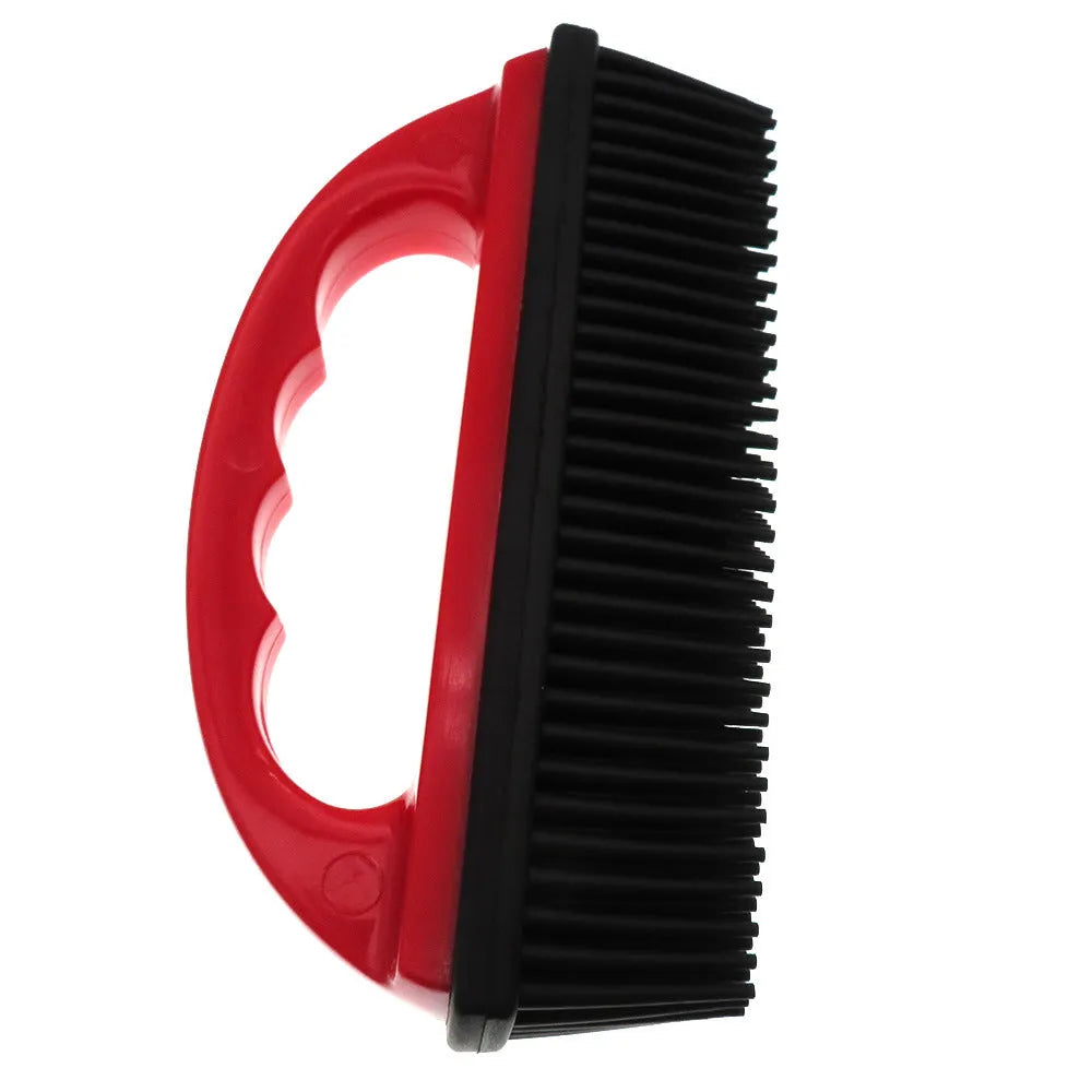 Red pet hair removal and massage brush for grooming and carpet cleaning.