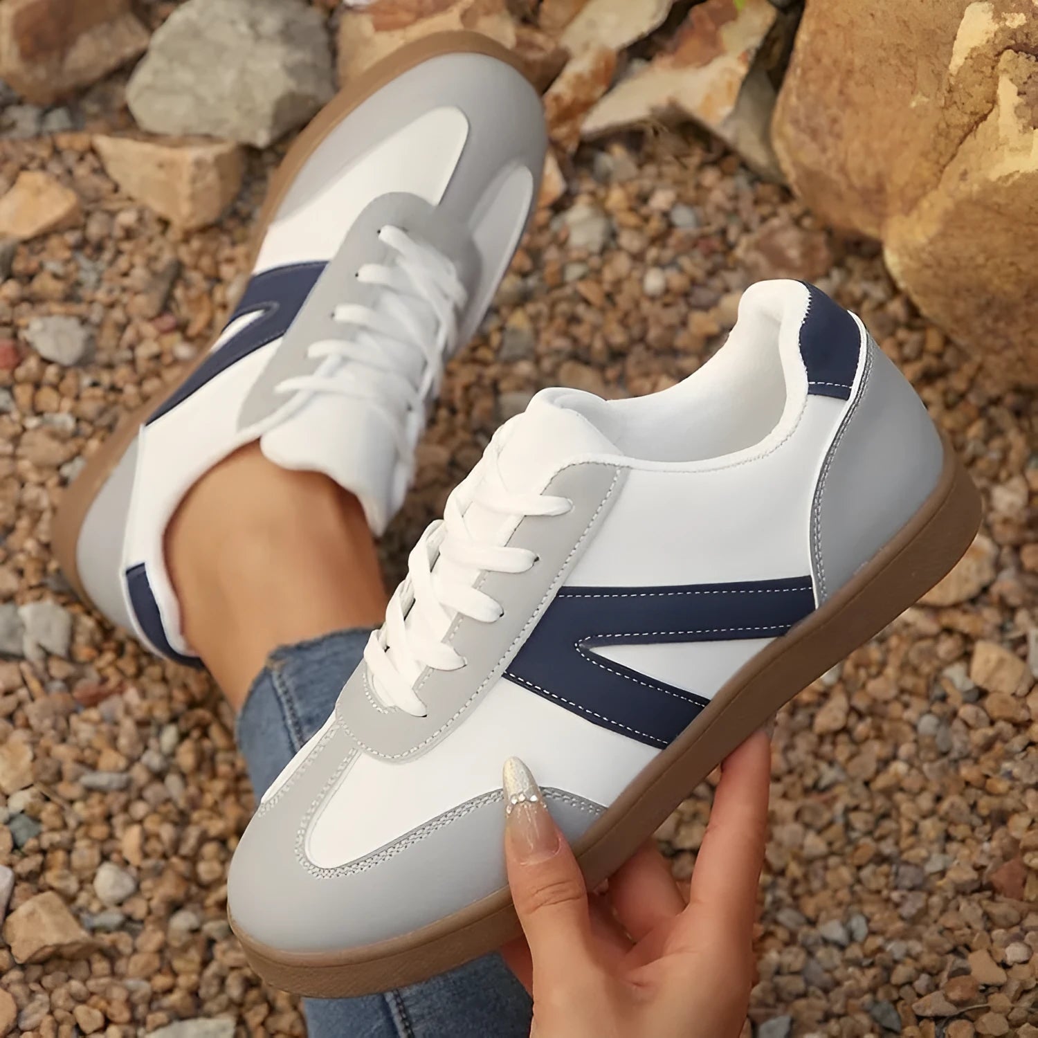 Blue women's low-top lace-up hiking shoes with an artificial PU upper and rubber sole.