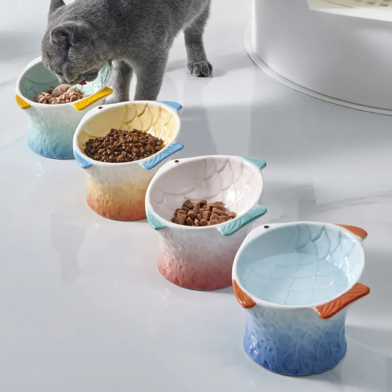 Fish-shaped ceramic cat bowls with 15-degree tilt angle in blue, green, pink, or yellow colours