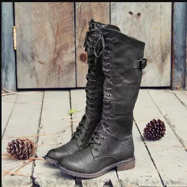 Women's black chunky heel high leg ankle boots on a white background.