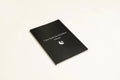 Black softcover Dream Journal notebook open on a table