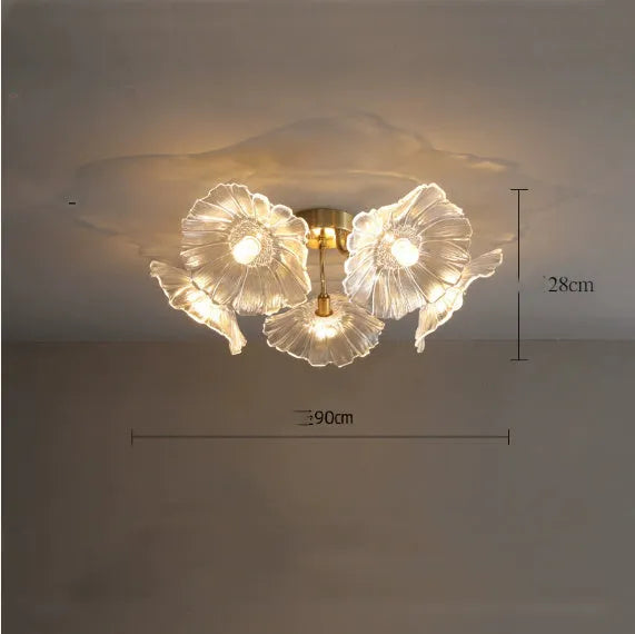 Modern white flower ceiling lamp with five light heads emitting a warm glow in a living room.