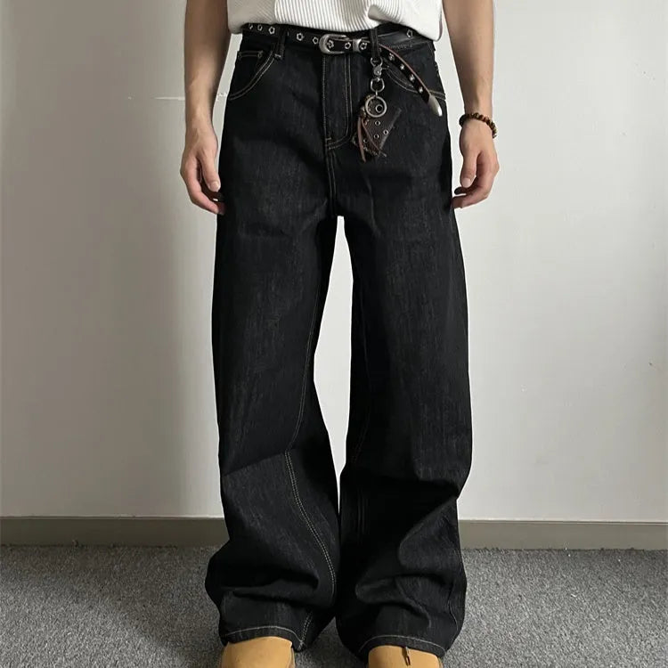 A pair of black loose wide-leg jeans with a straight-leg cut and zip fly on a mannequin.