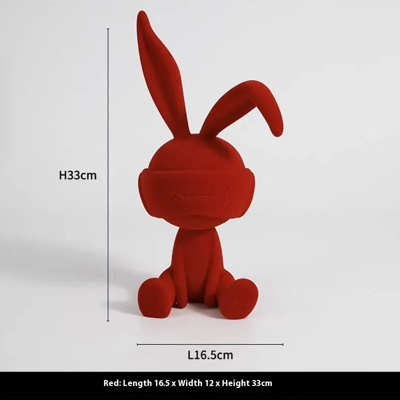Small resin rabbit table ornament with a suede blindfold, shown in green, blue, and red colour options.