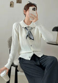 Beige lapel scarf collar acrylic cardigan with long sleeves on a hanger