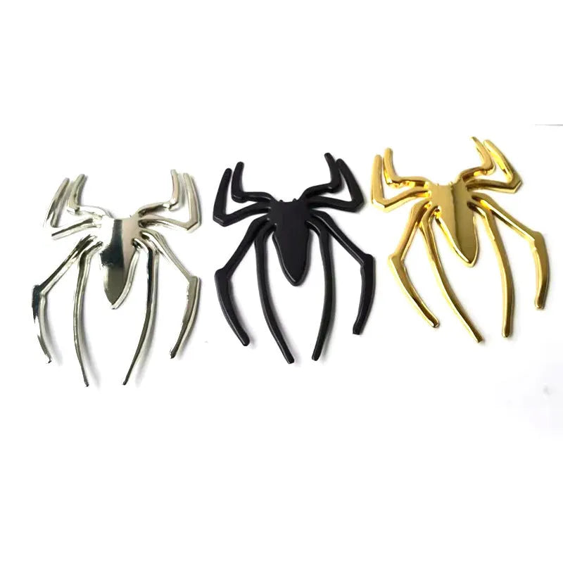 Three-dimensional metal spider bumper sticker in zinc alloy, shown in gold colour.