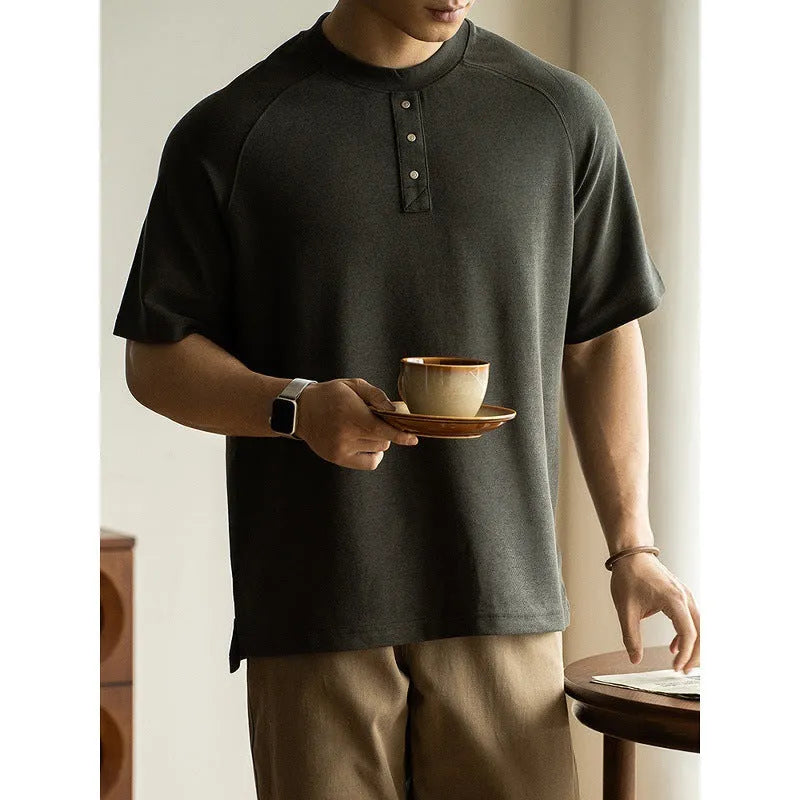 Women's loose grey casual pullover top with raglan sleeves on a hanger.
