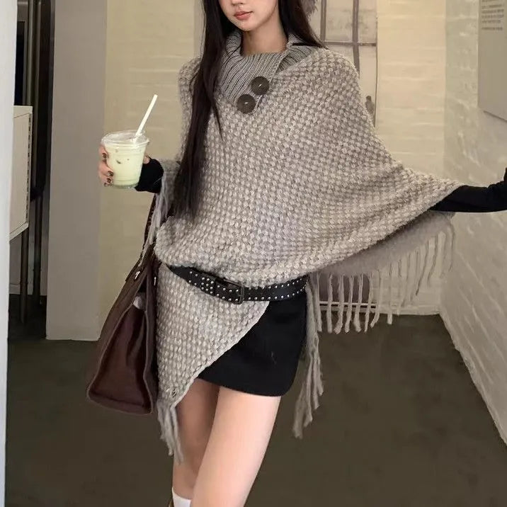 Women's plush cashmere blend triangle shawl cape with tassel trim in multiple colour options.