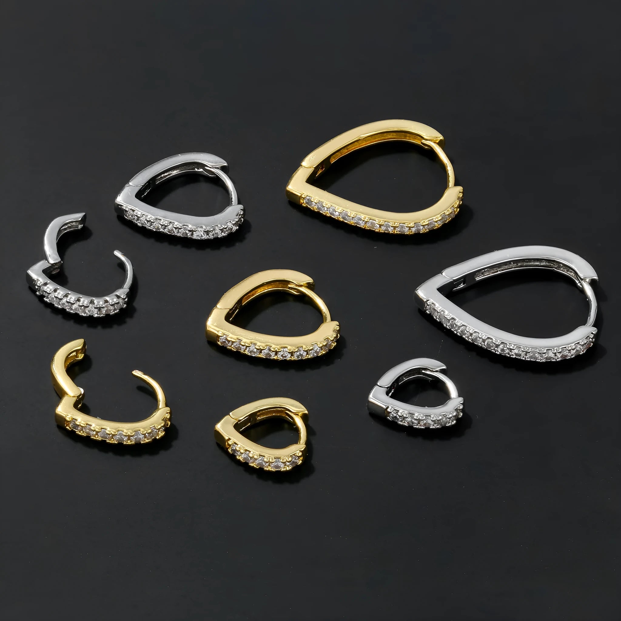 Geometric heart-shaped copper ear clip with electroplated gold finish on a white background.