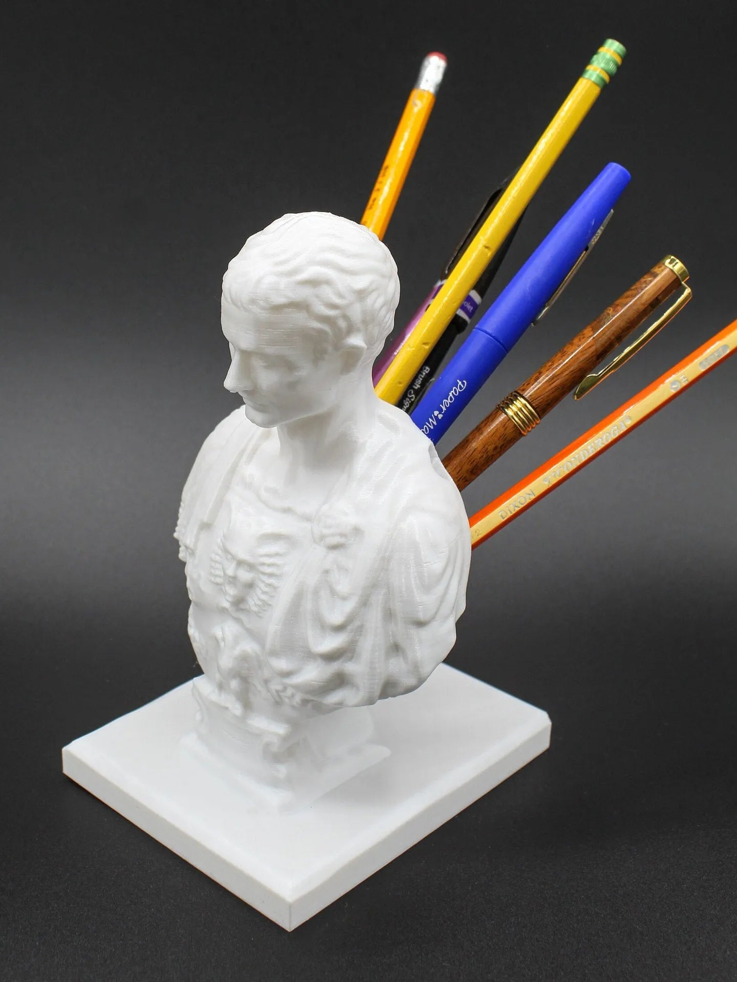 White American creative character synthetic resin pen holder on a desk.