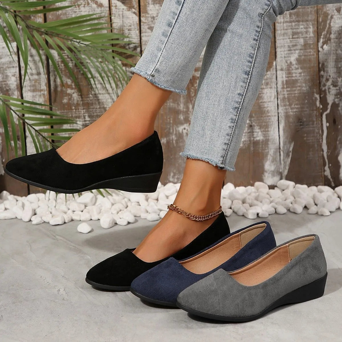 Women's suede wedge pump in light brown with a pointed toe and low rubber sole.