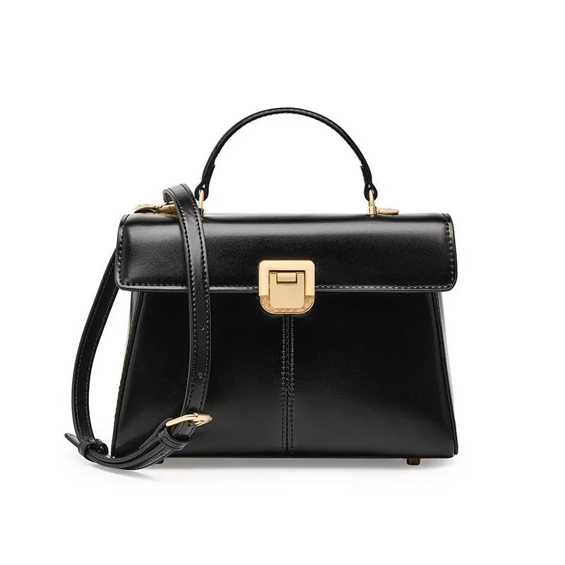 Women's black genuine leather shoulder bag with gold clasp closure showing interior compartments