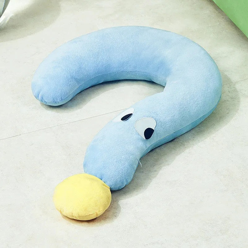 A rectangular blue pet sleeping pillow on a floor, shown next to a small dog for scale.