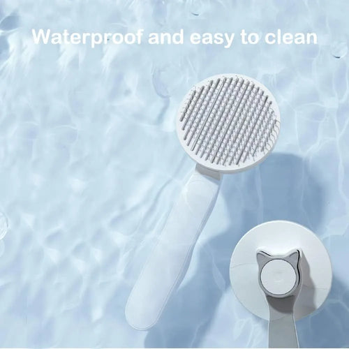 Blue self-cleaning cat brush with rubber handle and metal pins for pet grooming.