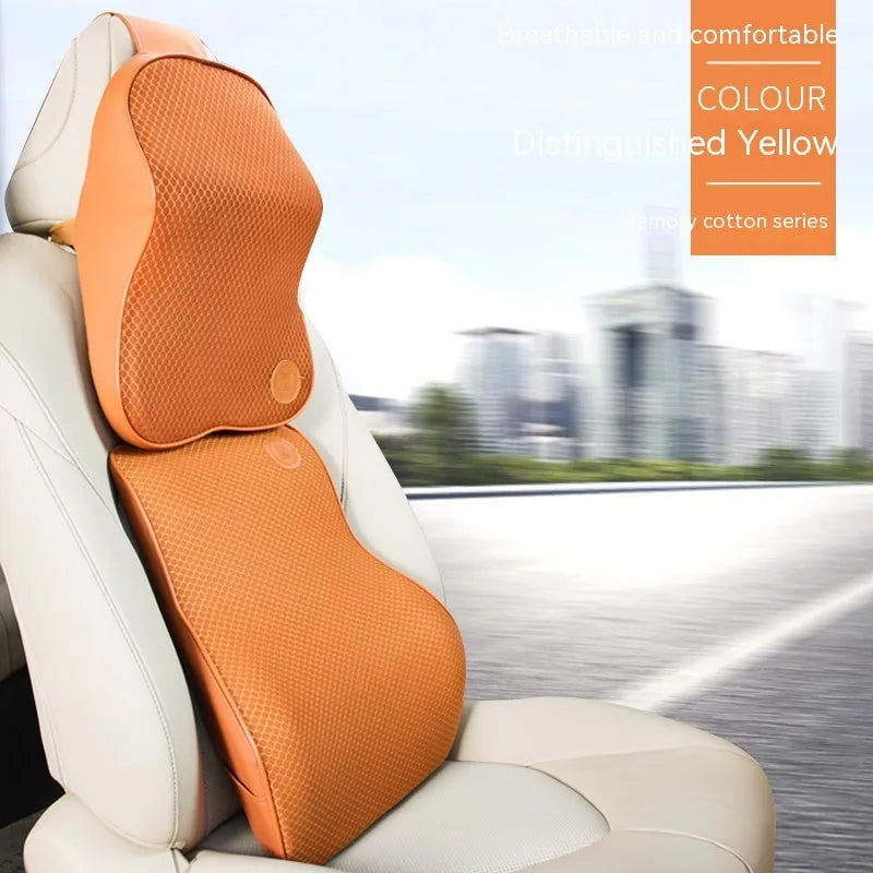 Black and brown memory foam car headrest and lumbar support pillows on a car seat.