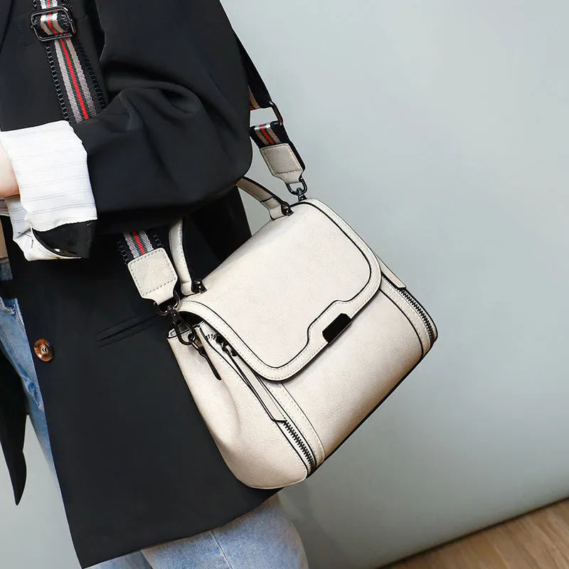 Women's brown genuine leather messenger bag with retro styling and multiple internal pockets