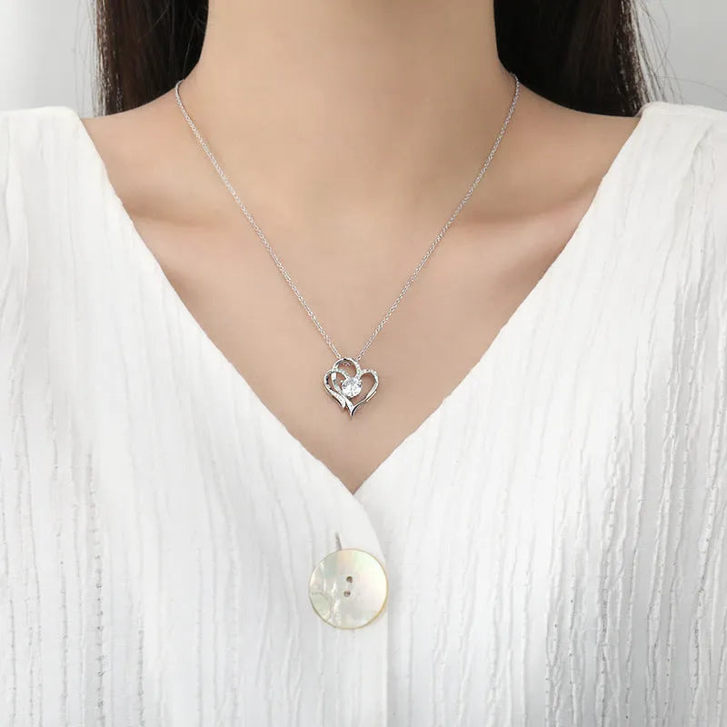 Women's heart-shaped silver necklace shown in rose gold, white gold, and yellow gold plating variations.