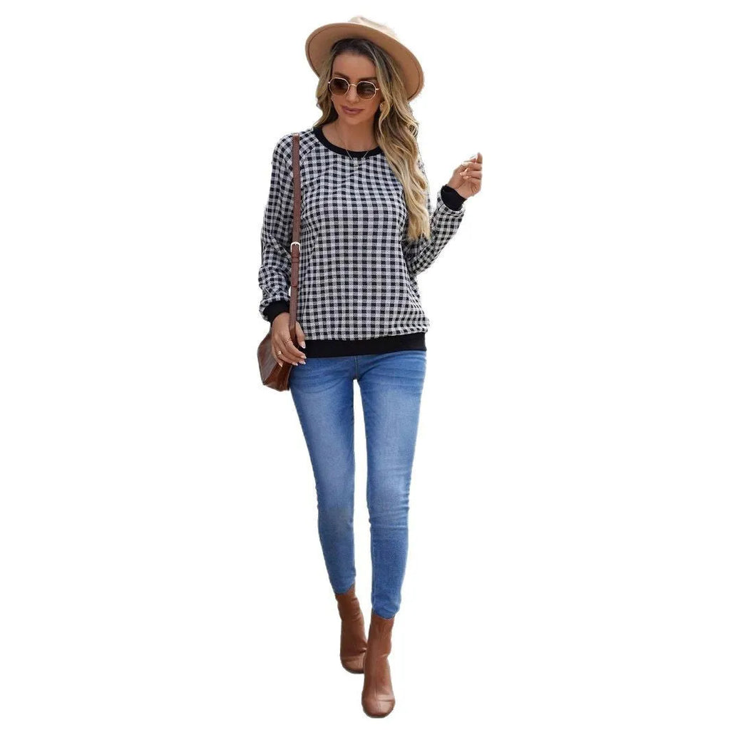 Black plaid and stripe pattern pullover sweater with long sleeves on mannequin